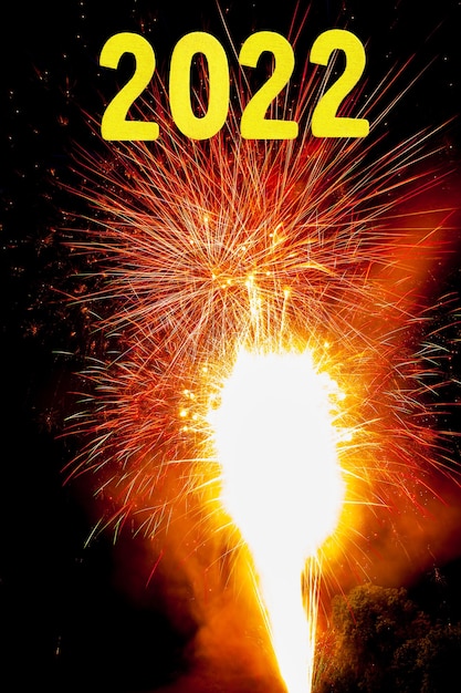 New Years card for 2022 with gold digits on a firework background.