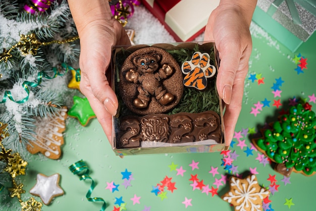 New years chocolate set in hand chocolate toy in the shape of tiger symbol of the year  joyful mood