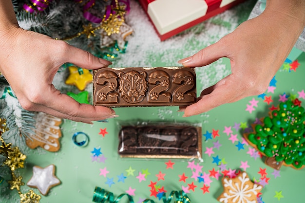 New years chocolate toy in hand chocolate toy in the shape of  symbol of the year joyful mood