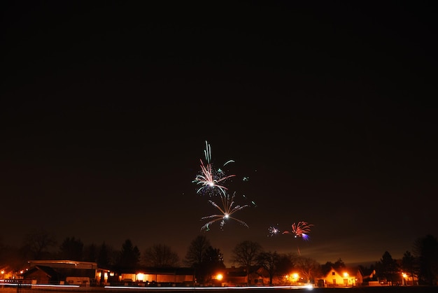 New years eve celebration in village with colorful fireworks at night