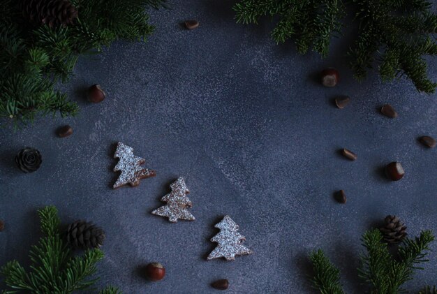 New years layout gray background with spruce branches cones nuts gingerbread