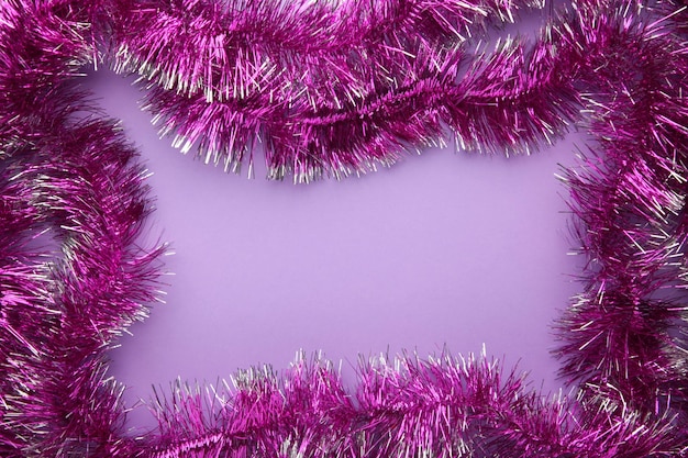 New years pink tinsel Christmas theme on purple background