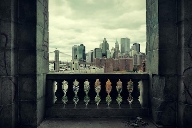 Orizzonte di architettura del centro di new york city attraverso il balcone abbandonato