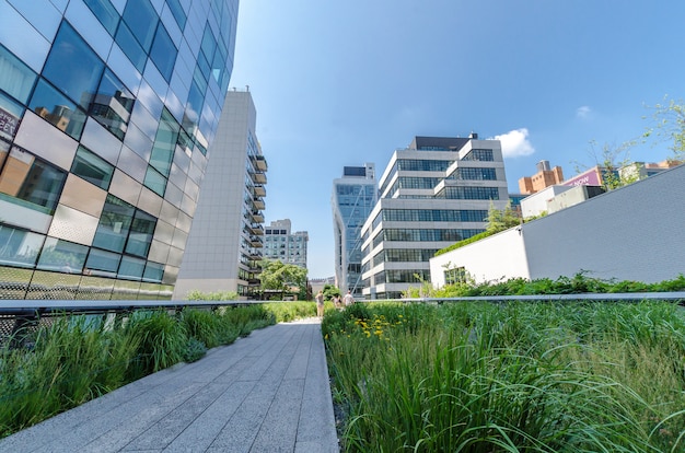 NEW YORK CITY - JULY 22: People walk along the High Line Park on July 22, 2014. The High Line is a popular linear park built on the elevated former New York Central Railroad spur in Manhattan.