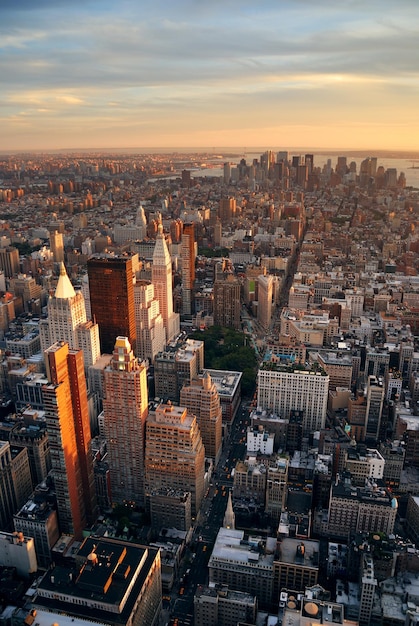 New York City Manhattan sunset skyline aerial view with office building skyscrapers and Hudson River.