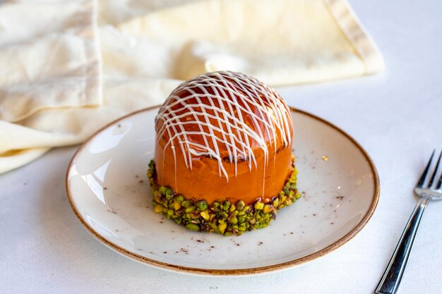 New York Pie on a white background New York Cake Strawberry Banana Raspberry Pistachio Caramel Chocolate Sauce is prepared close up