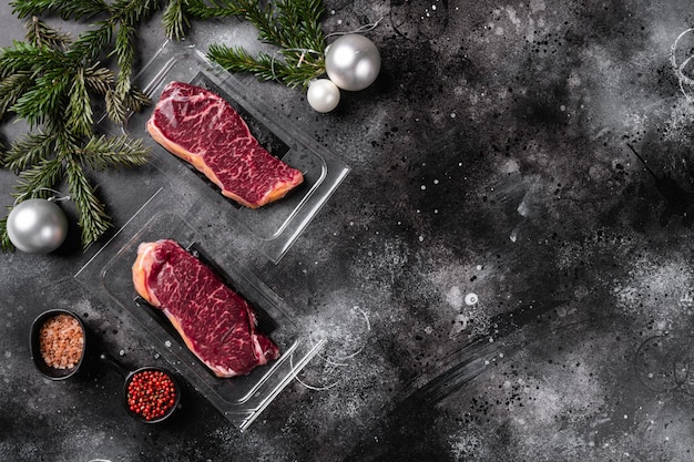 New-York steak pack new year decoration set, on black dark stone table background, top view flat lay, with copy space for text