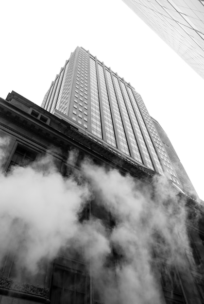 NEW YORK, USA - May 03, 2016: Manhattan street scene. Cloud of vapor from the subway on the streets of Manhattan in NYC. Typical view of Manhattan