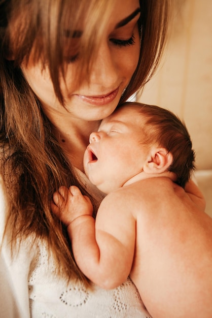 Newborn baby in the arms of young parents