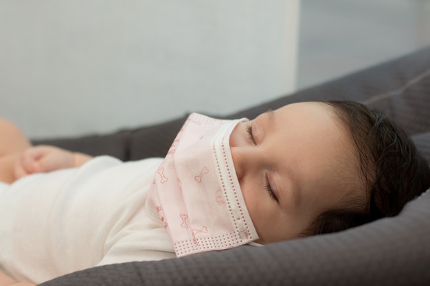 Newborn baby asleep in bed