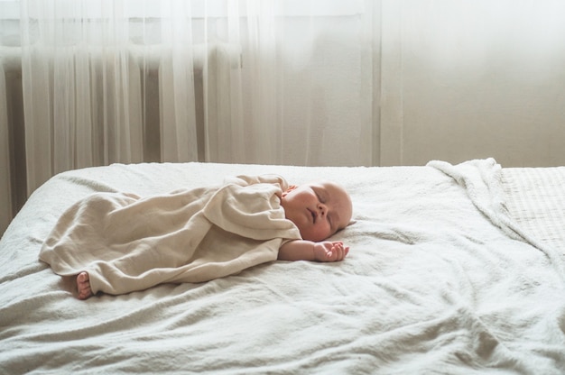 Newborn baby on the bed