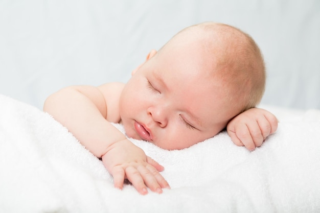 Newborn Baby Boy Sleeping Peacefully on Blue Blanket