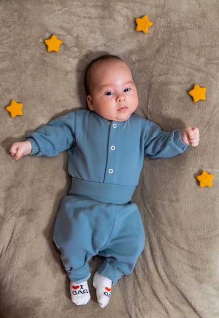 Newborn baby boy in suit on a brown background Stock photo