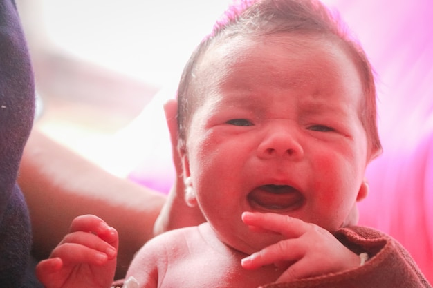 Newborn baby boy wailing 