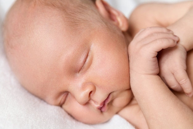 Newborn baby boy on a white background. Baby is sleeping.