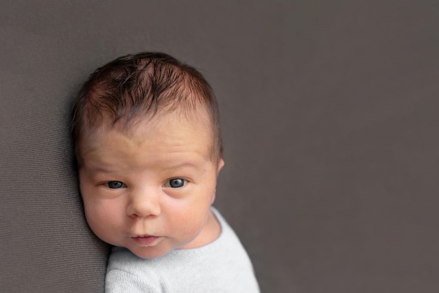 Newborn baby emotions. Funny face of a child, emotions.