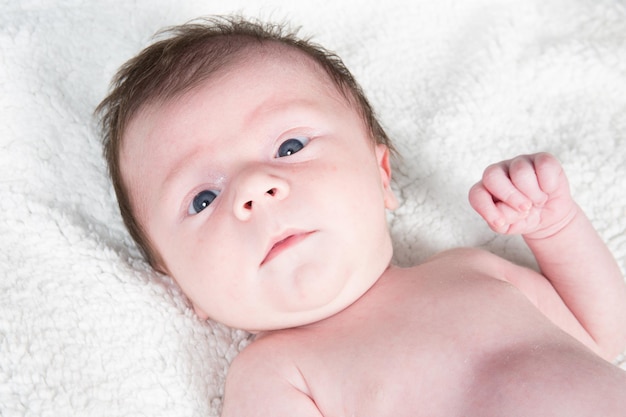 Newborn baby face in towels