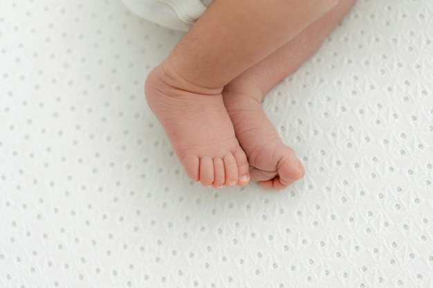 Newborn baby feet closeup on white background. Newborn natural and simple lifestyle photoshoot