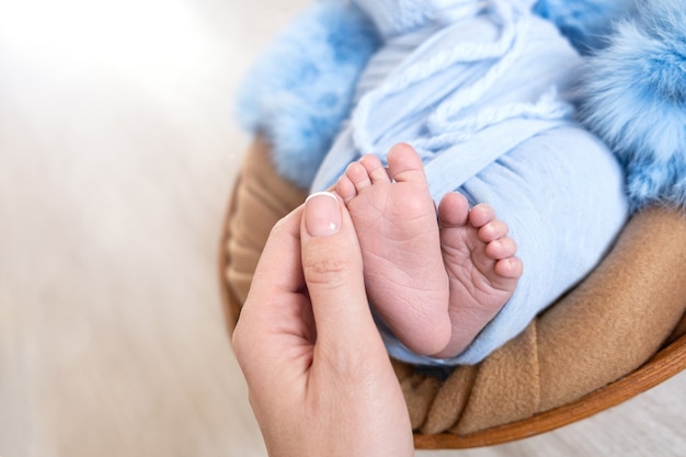 Newborn baby feet in hands