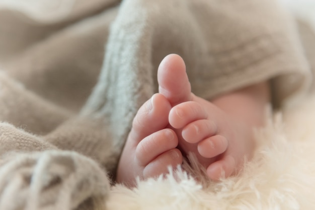 newborn baby feet on soft fabric