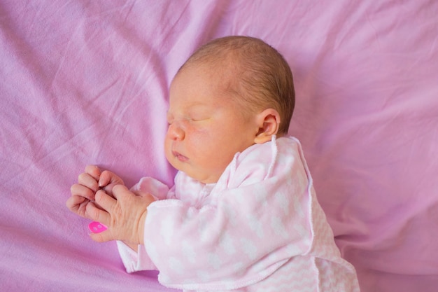 Newborn baby first days of life in delivery room.