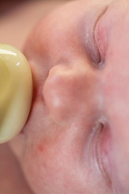 Newborn baby girl at feeding time.