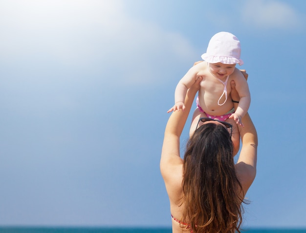 Newborn baby girl playing with mom.