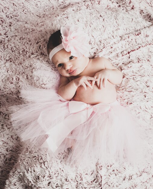 Newborn baby girl wearing a pink ballerina tutu