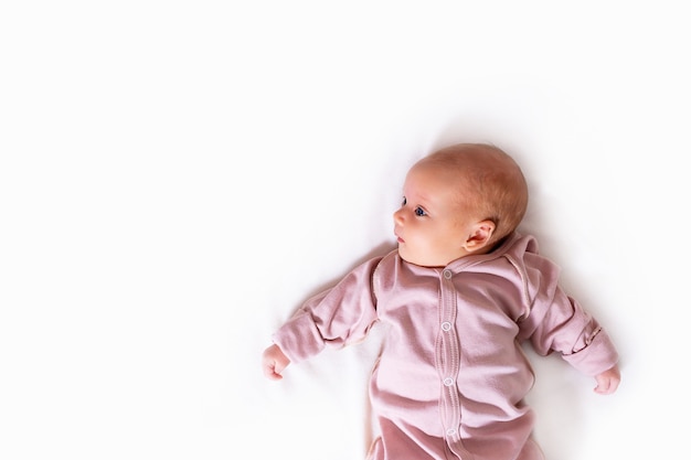 Newborn baby girl on white  copy space