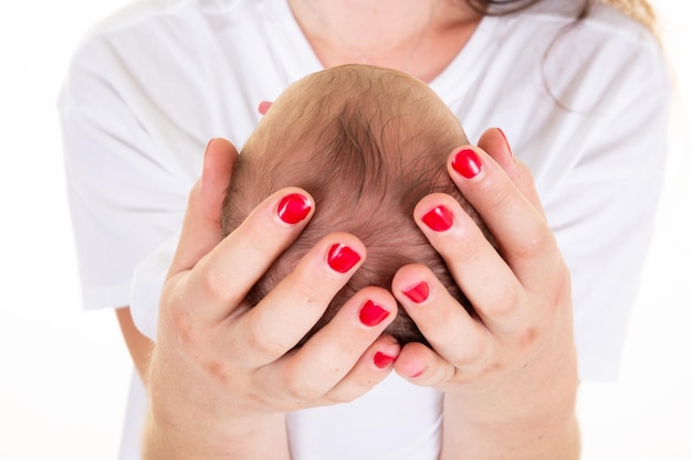 Newborn baby head in mother hands