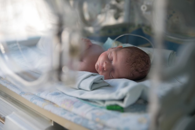 A newborn baby in an incubator