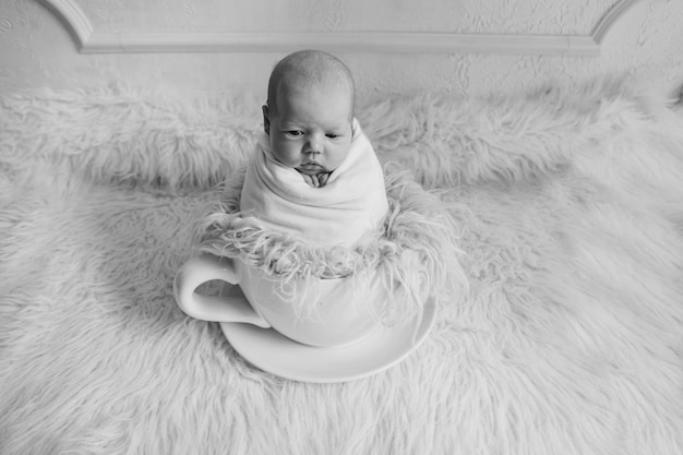 newborn baby in a large tea Cup.  childhood, health, IVF, hot drinks, Breakfast