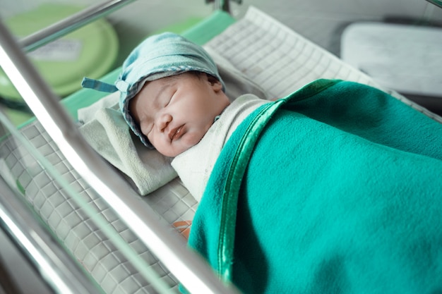 Newborn baby laying in crib