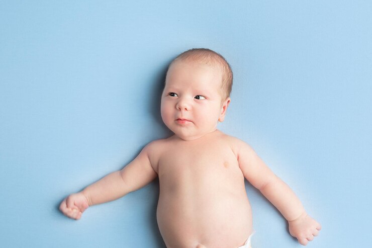 newborn baby lies on a blue background portrait of a little boy