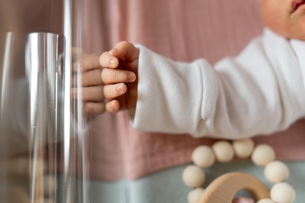 Newborn baby lying in a cot in maternity department in a hospital baby tiny hand close up new life