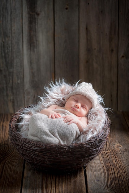 Newborn baby sleeping in the basket on blanket