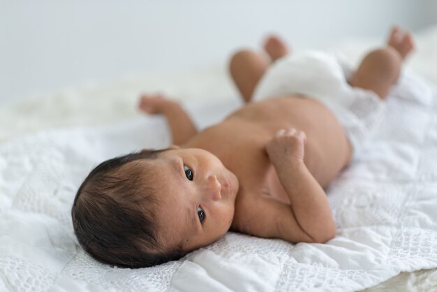 Newborn baby sleeping in bed