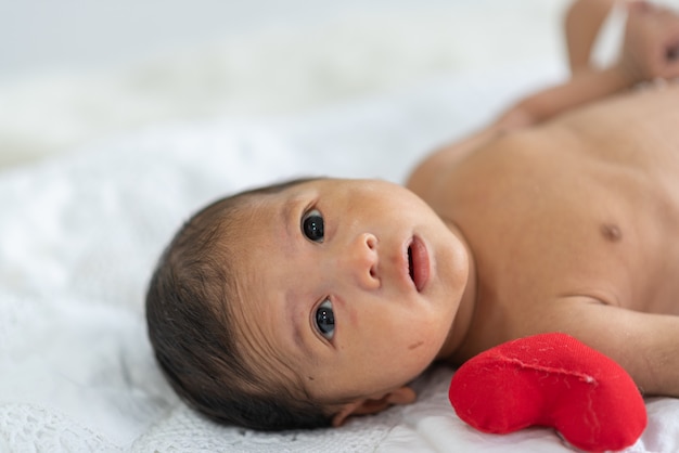 Newborn baby sleeping in bed