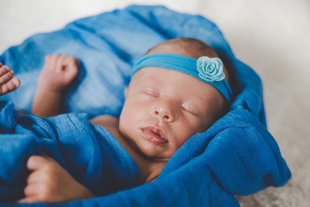 Newborn baby sleeping on a blue background. Selective focus. people.