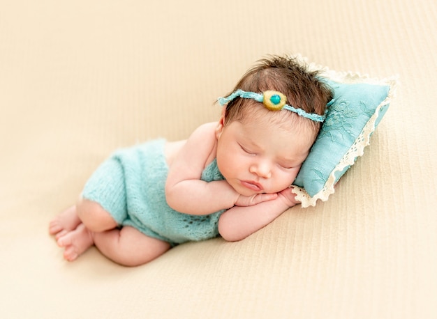 Newborn baby sleeping on a little pillow