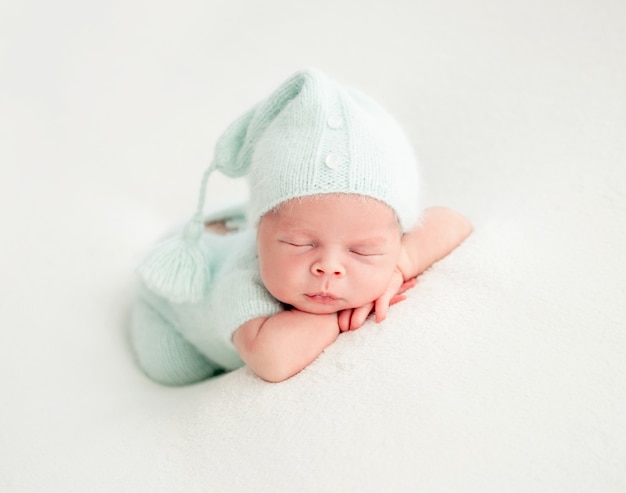 Newborn baby sleeping in mint clothes