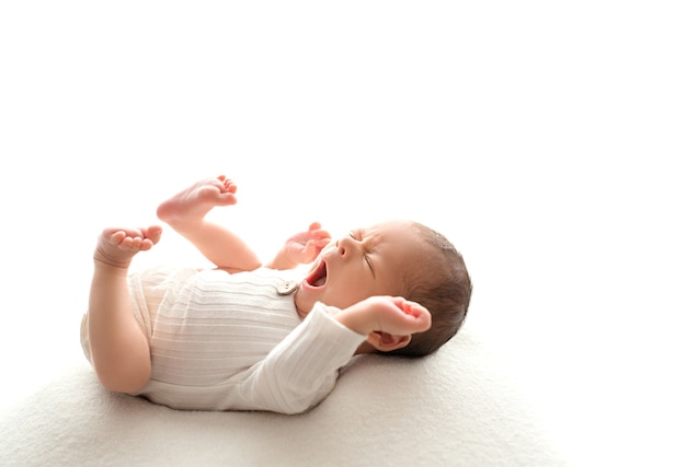 Newborn baby, white background, soft focus. High quality photo