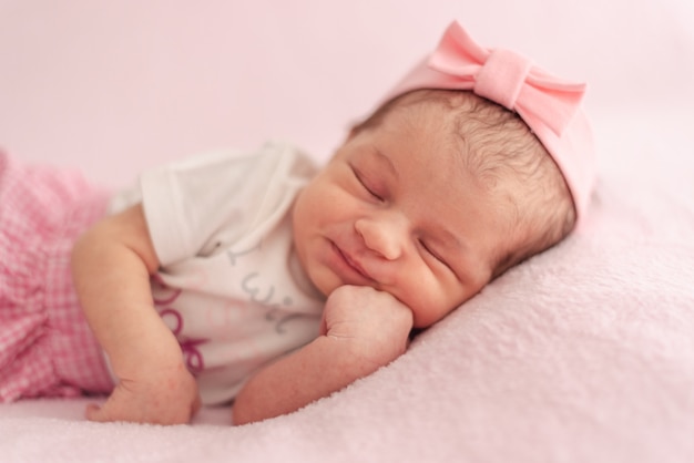 A newborn baby with a headband