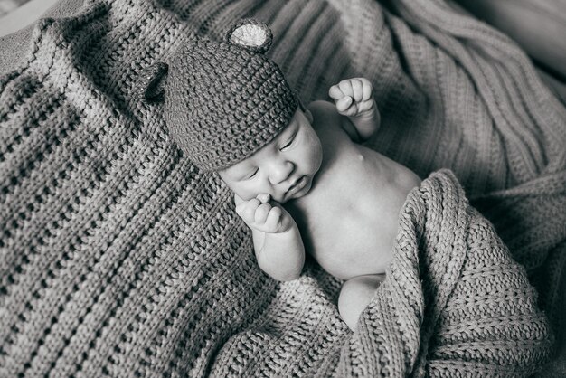 Newborn boy lies on a plaid