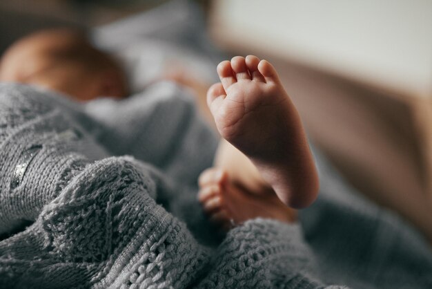 Newborn boy lies on a plaid