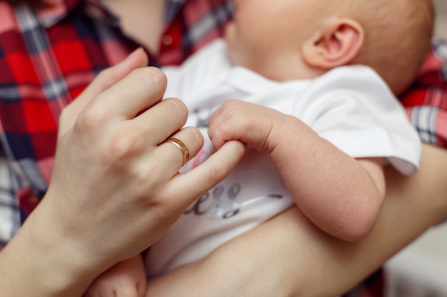 Newborn children's hand in mother hand