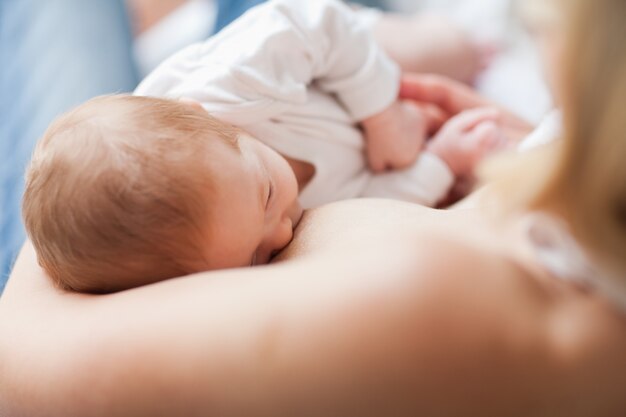 Newborn getting suckled