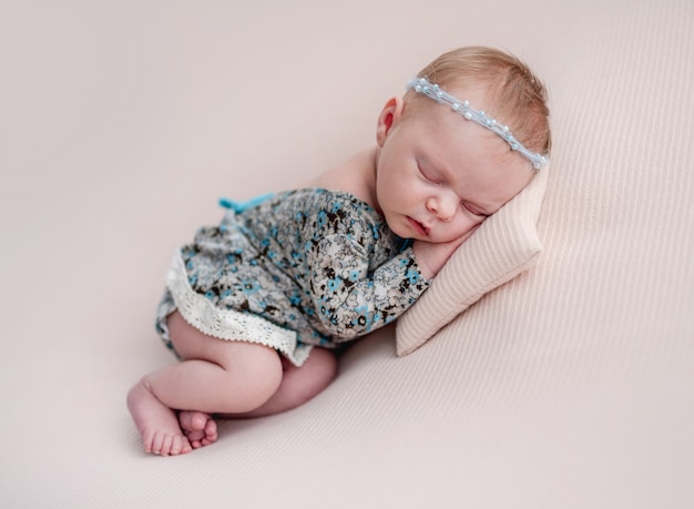 Newborn girl wearing diadem and dress