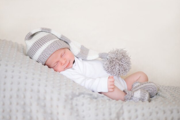 newborn infant, the baby is sleeping lying on his stomach on a soft blanket