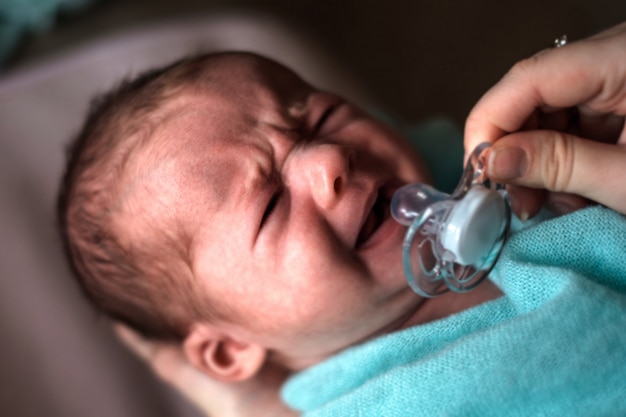 Newborn little baby girl in parents hands